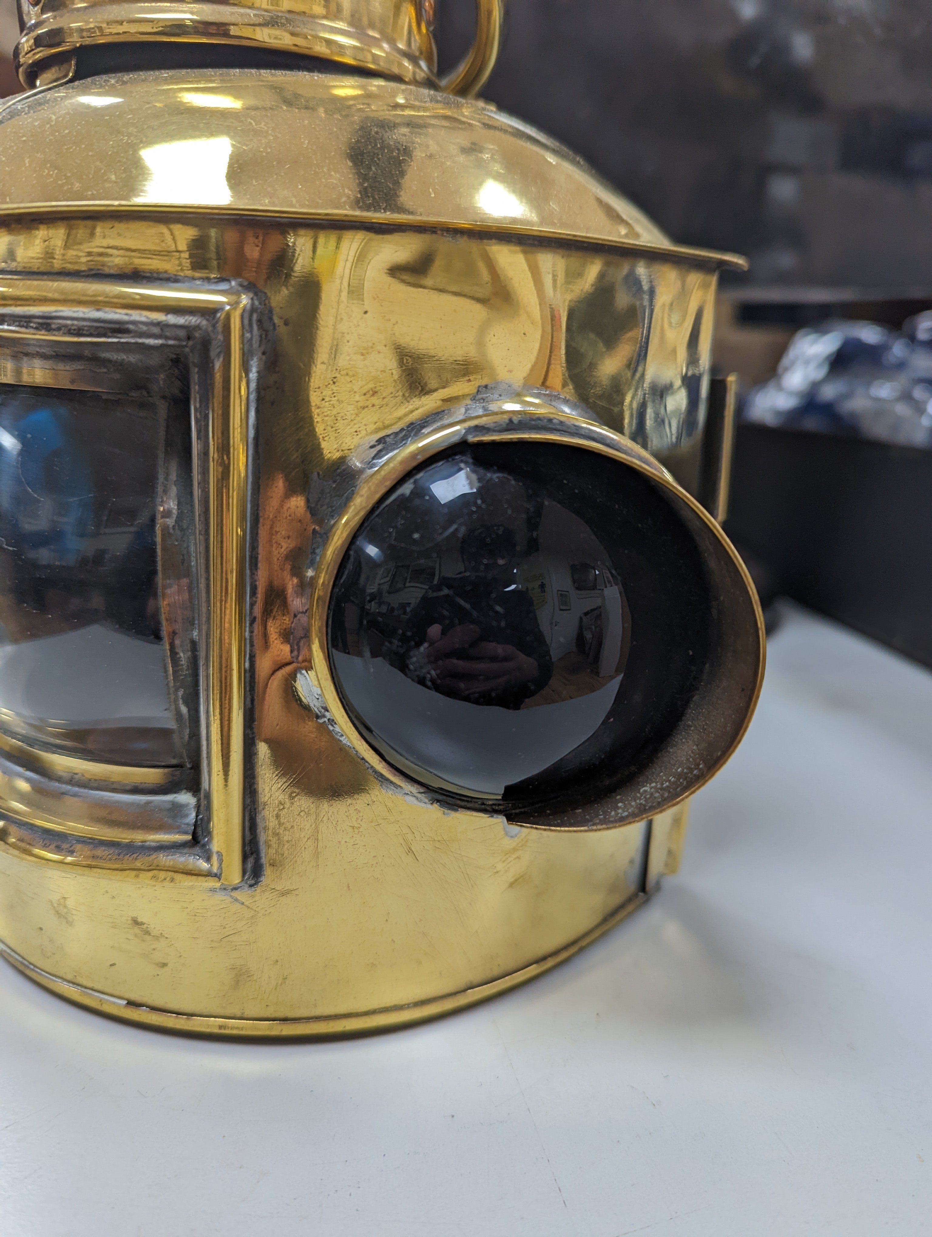 A copper ship's binnacle compass, a brass oil lamp, a brass jug and a copper kettle